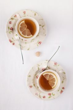 two teacups with orange slices on them