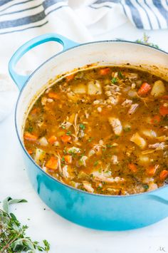 a blue pot filled with soup sitting on top of a table