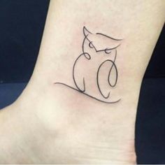 a small tattoo on the ankle of a person with an owl symbol in it's left foot