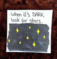 a piece of paper that says when it's dark, look for stars