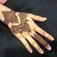 the hand is decorated with henna designs