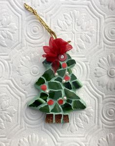 a christmas tree ornament hanging on a wall