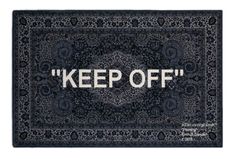 a rug with the words keep off written on it in white letters and black background