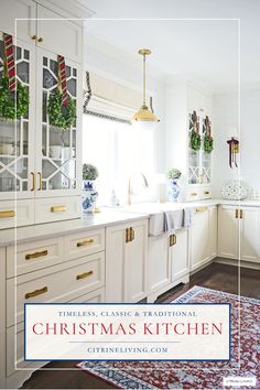 a kitchen with white cabinets and christmas decorations on the counter top, along with a red rug