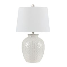 a white table lamp with a white shade