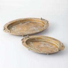 two oval metal trays with handles on each side