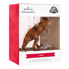 an ornament in the shape of a t - rex is packaged for christmas