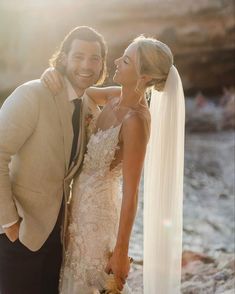 a bride and groom standing next to each other