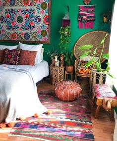 a bedroom with green walls and colorful rugs