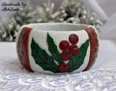 Christmas bangle bracelet is made of polymer clay in Christmas colors - white, red and green.It combines different cozy winter textures - rude domestic fabric, knitting, faux brown leather with snowflakes tissue and bright leaves and berries of the holly - the symbol of Christmas.It can be a really great Christmas or New Year gift for your beloved woman to make her smile and to give her a cozy feeling.Bracelet width 4,5 cm (1,77")Inner circle 20 cm (7,87")Can be made in different sizes and color Handmade White Bangle As Gift, Handmade White Bangle For Festive Occasions, White Handmade Bangle For Festive Occasions, Handmade White Christmas Bracelet, Xmas Gifts For Her, Bracelet Christmas, Winter Jewelry, Handmade Beauty Products, Christmas Bracelet