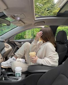 a woman sitting in the back seat of a car