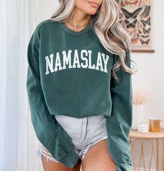 About the sweatshirt 👕 This Namaslay Sweatshirt is Unisex fit, please first refer to the measurements in the product photos and choose your size. If you are looking for a size you can't see on the listing, please contact us and we will see if its possible! The Comfort Colors 1566 is 80% ring-spun cotton, 20% polyester, medium-heavy fabric (9.5 oz /yd² (322.1 g/m Our processing and production times ⏱️ Typical production time is between 2-7 days. This is the time it takes to produce the item befo Athleisure Long Sleeve Sweater With Letter Print, Varsity Style Tops With Letter Print And Long Sleeves, Varsity Style Long Sleeve Top With Letter Print, Varsity Long Sleeve Top With Letter Print, Long Sleeve Sweatshirt With Text Print For Loungewear, Long Sleeve Text Print Sweatshirt For Loungewear, Sports Sweatshirt With Text Print And Long Sleeves, Comfortable Fit Crew Neck Top For Leisure, Comfortable Crew Neck Top For Leisure