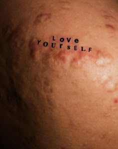 the word love yourself written on someone's back with blood all over his body