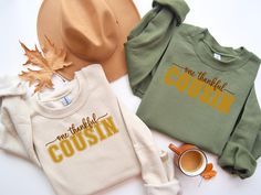 Thankful Vibes Cousin Sweatshirt Celebrate the spirit of Thanksgiving with our Thankful Vibes Cousin Sweatshirt! Perfect for bringing family together, this unisex pullover sweater is designed to spread warmth and gratitude. Featuring a trendy design with "Thankful Vibes" text, it's the ideal choice for cousins who want to share the holiday cheer in style. Unisex Thanksgiving Pullover Sweater Keep cozy this Thanksgiving with our Unisex Thanksgiving Pullover Sweater. The classic crewneck design and comfortable fit make it perfect for all-day wear, whether you're enjoying a family meal or watching the big game. Made for both men and women, this sweater is a versatile addition to any Thanksgiving wardrobe. Matching Cousin TShirt for Turkey Day Party Ideal for any situation, a unisex heavy blen Fall Crew Neck Top With Lettering, Thanksgiving Letter Print Crew Neck Top, Thanksgiving Letter Print Cotton Tops, Casual Crew Neck Tops For Thanksgiving, Casual Letter Print Tops For Thanksgiving, Casual Tops With Letter Print For Thanksgiving, Fall Cotton Tops With Lettering, Cousin Gifts, Family Together