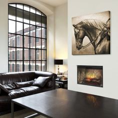 a living room filled with furniture and a fire place in front of a large window