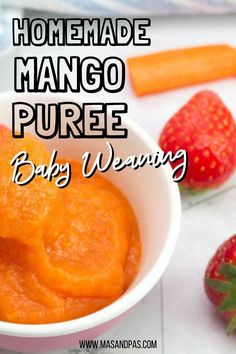 a bowl filled with mango puree next to two strawberries and a carrot on the side