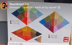 a person holding up a piece of paper with different colors on it