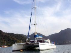 a white sailboat floating on top of a body of water