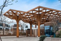 an outdoor covered area with benches and trees