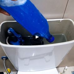 a person is pouring water into a toilet