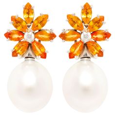 The orange sapphire and South Sea pearl earrings feature a cluster design on the ear with 6.90 carats of marquise cut faceted orange color sapphires of brilliant color, accented with 2 diamonds at the center. The tops suspend 2 South Sea pearls of 16.5 x 14.5mm All of our pearls are untreated: their natural color and high luster have not been enhanced in any way. The earrings are one-of-a-kind. They were handmade in 18k gold in Italy in our own workshop by maestro Scalabri according to an origin Diamond Flower Earrings, Pearl Diamond Earrings, South Sea Pearls Earrings, Diamond Earrings Design, Sapphire And Diamond Earrings, Golden South Sea Pearls, Pearl And Diamond Earrings, Orange Sapphire, Sea Pearl