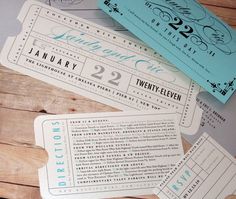 three tickets sitting next to each other on top of a wooden table with the numbers twenty and twenty