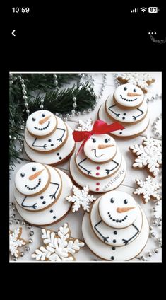 cookies decorated with icing and snowmen are arranged on a table