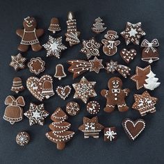 a pile of decorated cookies sitting on top of a black table next to each other