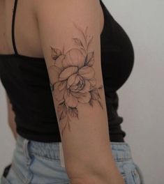 a woman with a flower tattoo on her arm