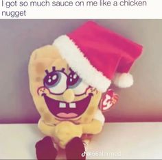 a stuffed toy wearing a santa hat on top of a table