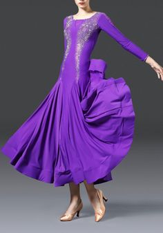 a woman in a purple dress is dancing