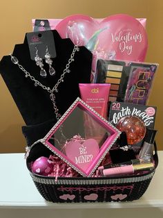 a pink and black gift basket filled with personal care items