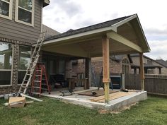 a house that is under construction with some tools on the ground