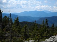 the mountains are in the distance with trees on each side