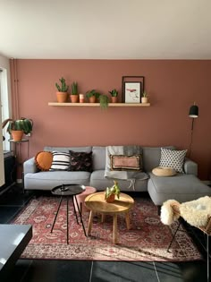 a living room filled with furniture and potted plants