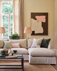 a living room filled with furniture and a painting on the wall