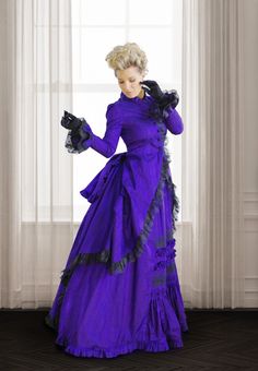 Whether attending a charity luncheon or walking in the park, everyone will want to know who made this bold ensemble. Not only is it bold, its details are anything but ordinary. The collar is inspired by the high neckline so common in the late Victorian era, but with ruffles and forming a v-neck. The jacket is cut in a polonaise style that is both comfortable and flattering, gathered in the back to highlight the stylish bustle. And no one will forget your calling card as you pass it to them while 1900 Dresses, 19th Century Dress, Victorian Era Dresses, Walking In The Park, Victorian Fashion Dresses, Victorian Gown, Victorian Dresses, Your Calling, Century Dress