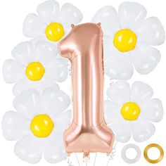 the number one balloon is surrounded by white and gold balloons with daisies on them