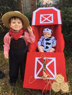 two dolls are dressed up as farm animals and one is sitting in a red wagon