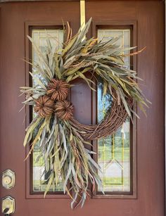 a wreath is hanging on the front door to give it a touch of fall color