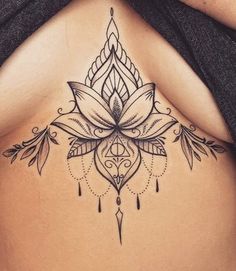 a woman's stomach with a tattoo design on the top and bottom part of her body