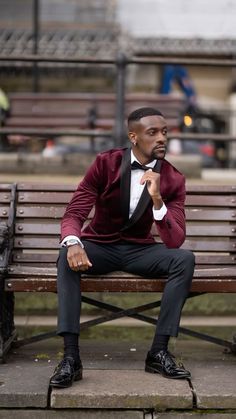 a man in a tuxedo sitting on a bench