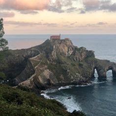 an island in the middle of the ocean with a house on it's head