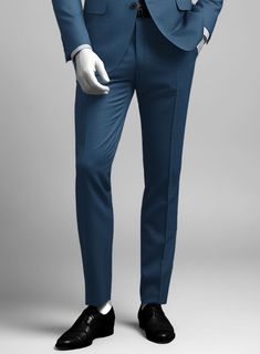 Bring some classic dignity, sophisticated style and warm touch to your work week wardrobe with our Napolean Casa Blue Wool suit. Crafted from wool blend, a long been piece with remarkable comfort and feel which complements the incredible versatility offered by its blue hue. Wear it with a matching waistcoat, a crisp white shirt, dotted light blue tie and brown dress shoes.  Look Includes   Napolean Casa Blue Wool Fabric  Two Button Jacket Style  Notch Lapel  Horn Royal Black Buttons  Single Vent  Three Cuff Buttons  Two Welted Back Pockets on Trousers    Click 'Customize Now' to modify the look if needed.   Lining: Viscose, Dry Clean, Pants can be lightly washed. Grey Tweed Suit, Herringbone Tweed Jacket, White Linen Suit, Green Velvet Jacket, Peaky Blinders Suit, Royal Blue Suit, Fabric Cross, Light Blue Tie, Brown Dress Shoes