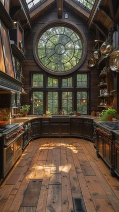 a kitchen with wooden floors and large windows in the ceiling, surrounded by potted plants