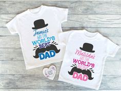 "Little ones can celebrate their Daddy this Father's Day with a beautifully personalised t shirt.  Our t-shirts are perfect as a surprise gift for Daddy, a way to document the special day together or as a beautiful keepsake.  With sizes ranging from 0-3 months up to size 9-10, all of the children can make Daddy's day with matching outfits! This design features the wording \"got the worlds best Dad\" in a bright pink or blue typography with a top hat and moustache illustration. Your little ones name is also featured at the top of the design in a handwritten font.  This design comes in 2 colour options, pink or blue. All our t-shirts are 100% soft touch cotton, which is perfect for children's delicate skin. All of our items are personalised to your specification, simply tell us what personal Father's Day White T-shirt With Custom Print, White T-shirt For Father's Day Gift, Father's Day Customizable Graphic T-shirt, Father's Day Customizable Graphic Tee, Moustache Illustration, Papa Tag, Blue Typography, Personalized Fathers Day Gifts, Father's Day T Shirts