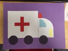 a piece of paper cut out to look like a hospital truck with a red cross on it