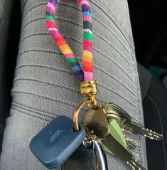 a car key chain with several keys attached to it's back seatbelts