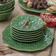 a table topped with green plates filled with food