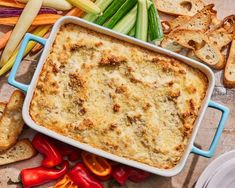 a casserole dish with vegetables and bread on the side, ready to be eaten